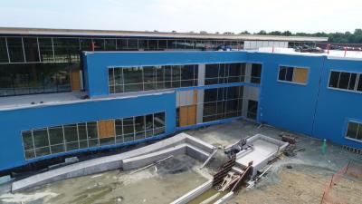 Construction updates: final exterior finishes and installation of rooftop solar panels.