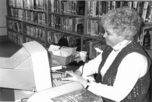Long-time librarian, Kathy Styer, becoming acquainted with the North East branch’s first computer in 1990. 