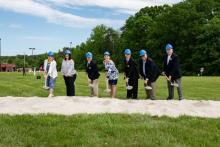 CCPL Board of Trustees digging into the earth with shovels