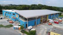 Construction updates: final exterior finishes and installation of rooftop solar panels.